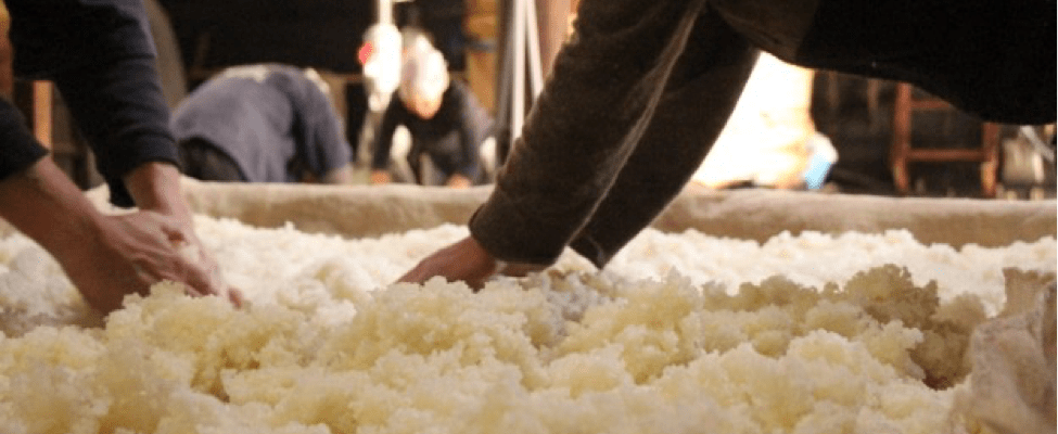 two sets of hands flip steamed rice to help if cool